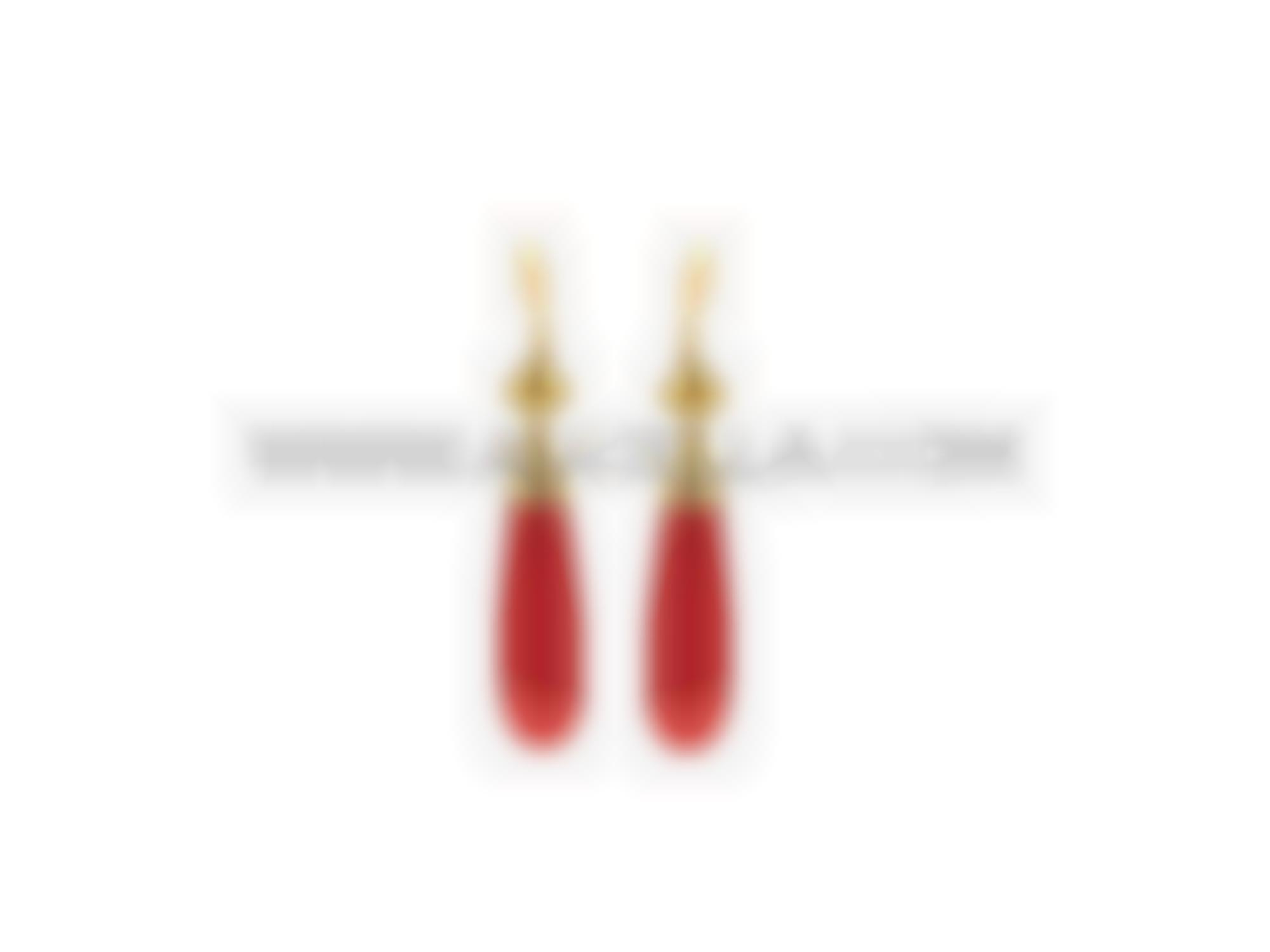 Earrings set in gold with coral drop