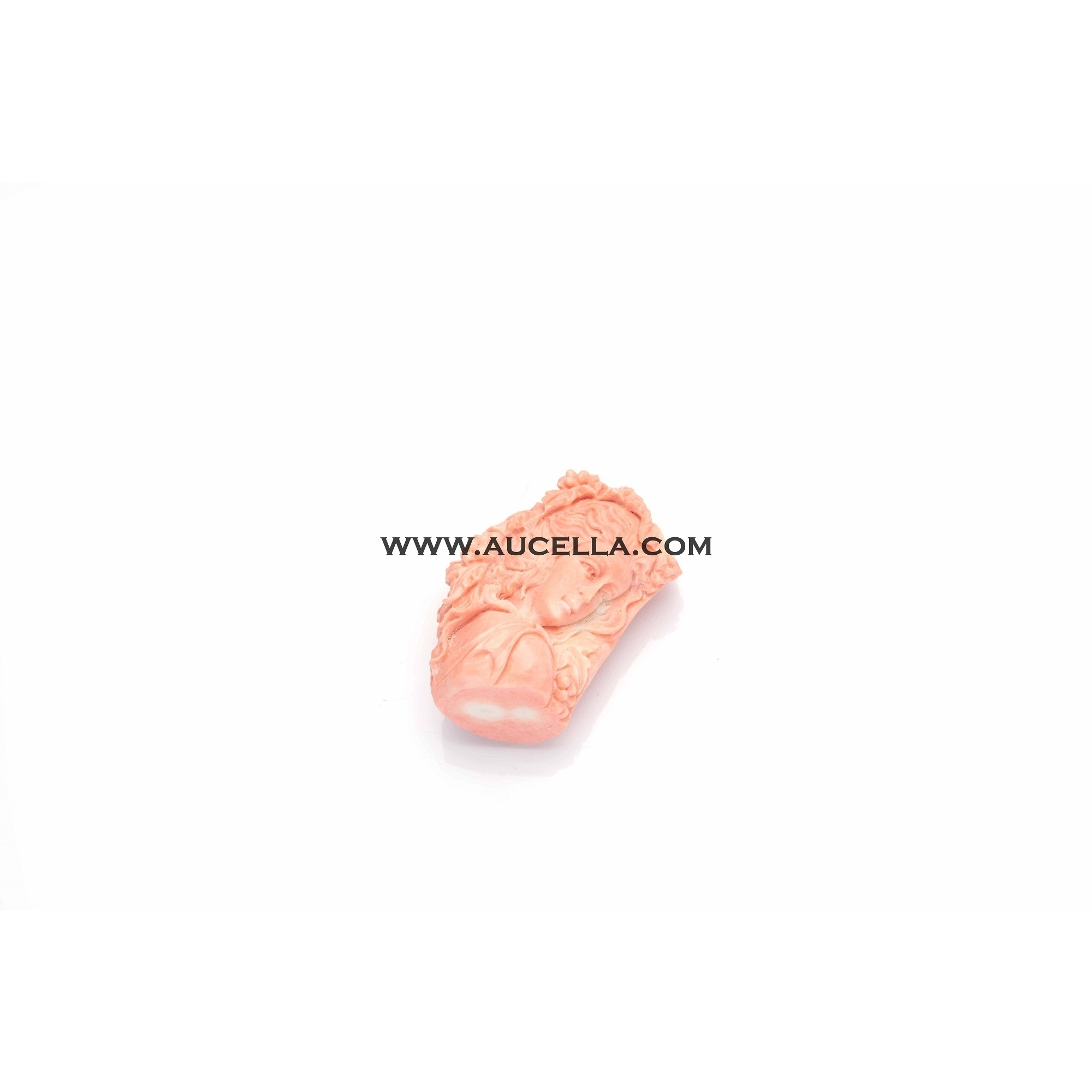 Carving face on pink coral