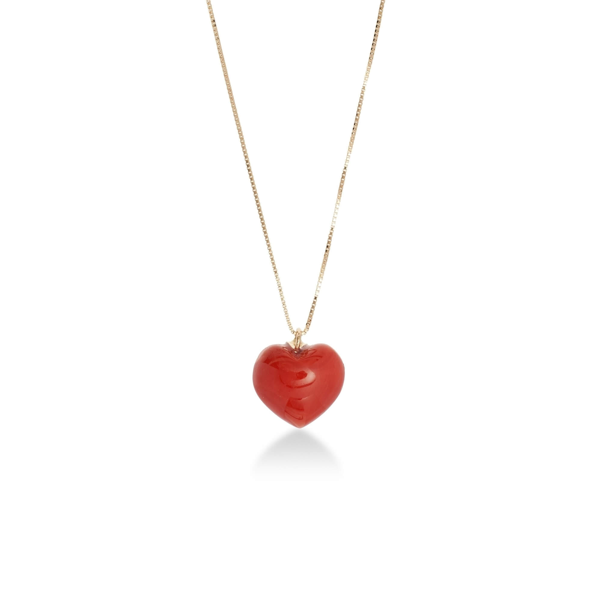 Natural coral carved as heart and set in gold 