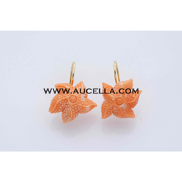 Earrings set in gold with coral starfish