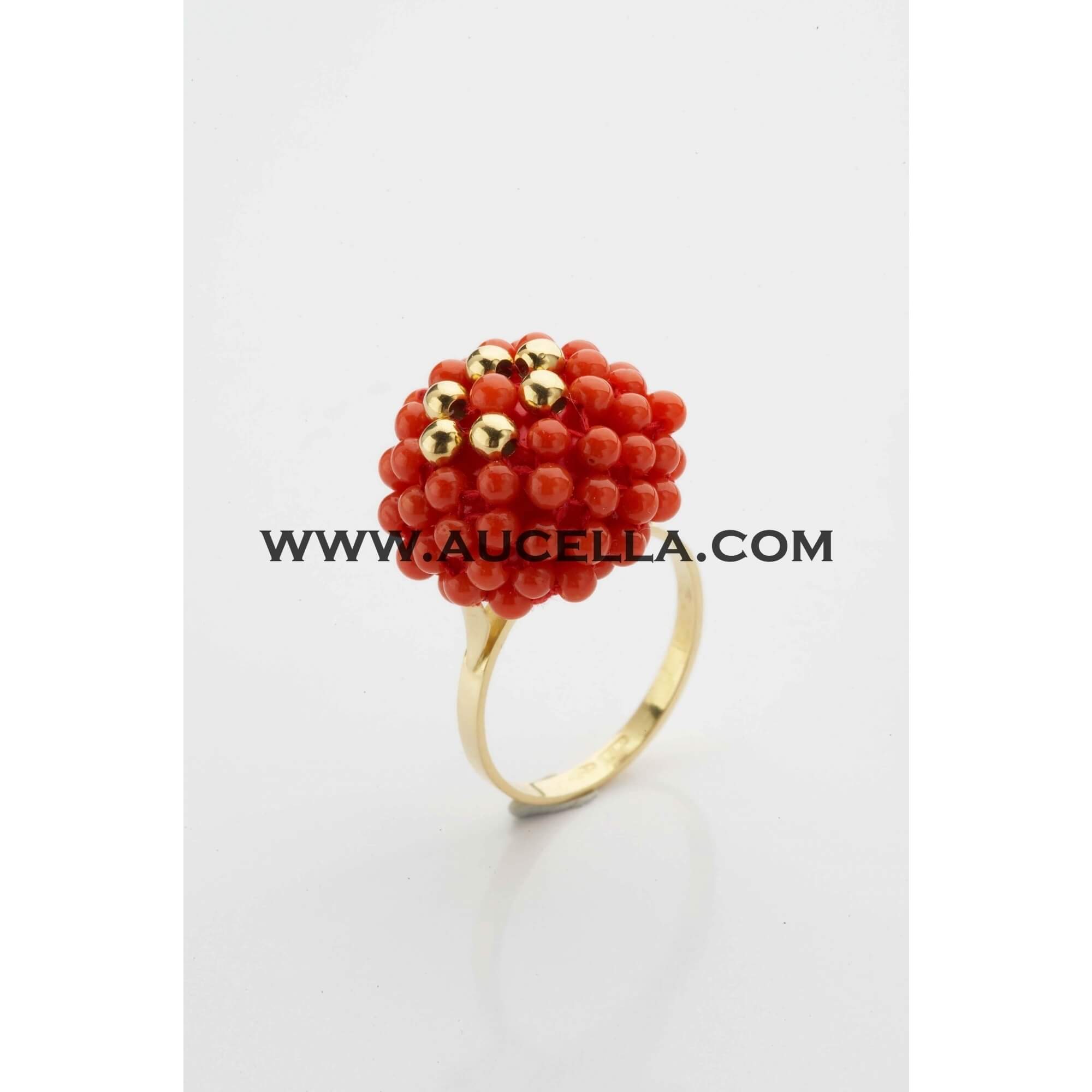 Ring set in gold with small coral beads 