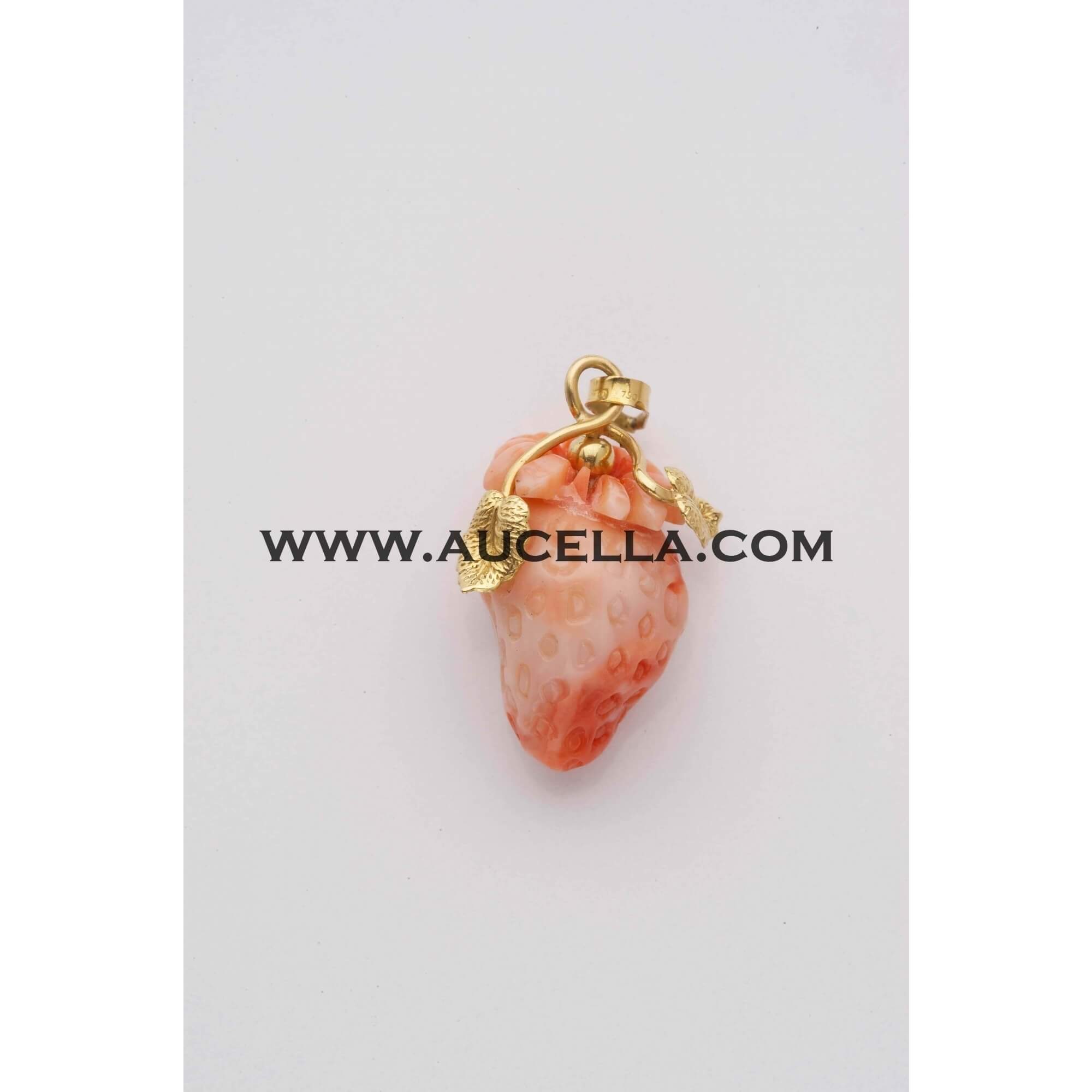 Pendant set in gold with carving fruit in coral